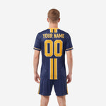 Custom soccer uniform kits for teams navy blue, back view showing player name arc and back number in athletic gold sublimated print