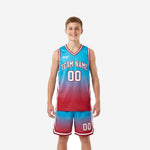 Gradient fade teal youth basketball uniforms with red shorts - full 2-piece set front view showing arced team name and number 00