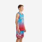 Side view of teal and red gradient youth basketball uniforms showing white side panel stripe on shorts and V-neck collar binding