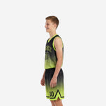 Side view of black and neon lime gradient youth basketball uniform set showing armhole binding and shorts side split chevron detail