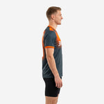 Left side view of sublimated graphite and orange mens soccer training top showing orange sleeve cuff trim and athletic cut