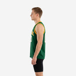 Side view of green and gold sublimated basketball jersey showing straight hem side vent at the hip seam and flat gold armhole binding on forest green fabric