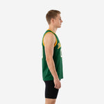 Custom green and gold basketball jersey front view on adult male model showing gold V-neck binding armhole trim and arced team name across the chest