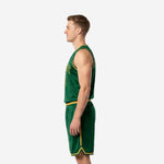 Second side view of green and gold custom basketball uniform showing V-notch gold hem detail on basketball shorts and full side profile