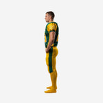 Custom sublimated football uniform side view from opposite angle showing green jersey body, gold shoulder panels, and fitted gold football pants