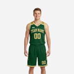 Green and gold reversible basketball uniforms showing both the forest green side and gold side of the full two-piece set with front and back numbers