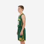 Second side view of green and gold youth basketball uniform set showing gold hem band and side panel accent on matching shorts