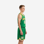Front view of custom green and gold youth basketball uniform with arced team name and number on kelly green dot-splash jersey