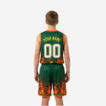 Opposite side view of green youth basketball jersey and shorts set showing flame sublimation detail on shorts lower panel and orange trim