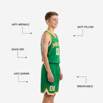 Opposite side view of youth basketball uniform in kelly green and gold showing shorts waistband drawcord and dot-splash leg panels
