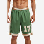 Custom green and white basketball shorts with cream side panels, gold stripe waistband, and player number 17 on front thigh - front view