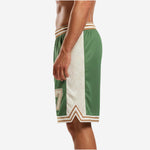 Close detail of the cream side panel on custom green basketball shorts with tonal leaf sublimation pattern and gold border stripe