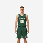 Green and white reversible basketball uniforms front view showing forest green jersey with topographic wave pattern and cream team name number