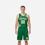 Green and white reversible basketball uniforms front view showing forest green jersey with cream slash graphic and matching shorts on adult male player
