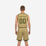 Opposite side view of the green and white reversible basketball uniform set showing the tan-gold dominant side construction