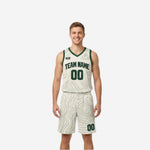 Cream and green reverse side of custom reversible basketball uniform set with topographic wave pattern and dark green team name number on white base
