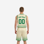 Side view of the cream-white reverse side of the reversible basketball uniform showing green dot-fade pattern and clean armhole binding