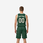 Side view of green and white reversible basketball uniform showing topographic wave pattern running edge to edge on forest green jersey and shorts