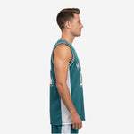 Front view of teal green basketball jersey with white side panels, black and white striped armhole binding, and bold front number 23