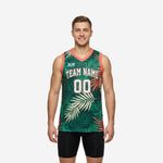 Green basketball jerseys with all-over tropical palm-leaf sublimation, coral armhole binding, arched team name and front number, front and back view