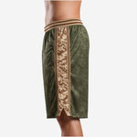 Detail side view of custom green basketball shorts highlighting the striped elastic waistband with internal drawcord and camo panel trim border