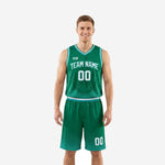 Front view of a custom green basketball uniform with flame graphic jersey and teal trim, arched team name and number 00 on chest, matching dot-fade shorts