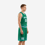 Side view of the custom green basketball uniform showing teal and white V-neck binding, armhole trim, and dot-fade shorts hem pattern on a male model