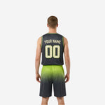 Side view of green and black reversible basketball uniform showing armhole binding, side panel gradient, and shorts silhouette on male athlete