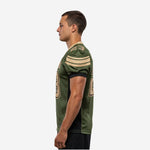 Left side view of olive green club football jersey displaying gold shoulder stripe detail, sleeve TV number placement, and black mesh ventilation panel along the ribs