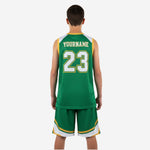 Opposite side view of green and gold youth basketball uniform set showing jersey side panel construction and shorts leg number placement