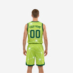 Opposite side view of the green and white reversible basketball uniform showing lime side panel and shorts hem band