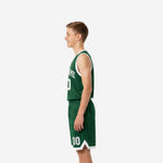 Left side view of green youth basketball uniforms showing elastic waistband shorts and sleeveless jersey with white crew-neck binding