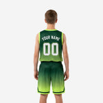 Opposite side view of custom youth team basketball uniforms in forest green and lime green gradient with chevron hem stripe detail