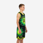 Side view of custom green and black youth basketball uniform set showing starburst sublimation pattern on jersey and shorts with neon trim binding