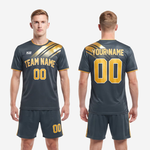 Full flat-lay of complete grey and gold custom men's soccer uniform set including jersey and matching shorts