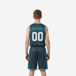 Opposite side view of custom grey youth basketball uniforms displaying teal side trim and shorts chevron notch on youth player
