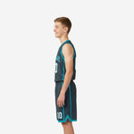 Side view of grey youth basketball uniforms showing white torso accent strip and charcoal shorts with teal chevron hem detail