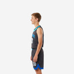 Side view of grey youth basketball uniform showing royal blue side panels on jersey and shorts cyan armhole binding and blue chevron notch at shorts hem