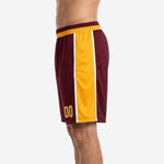 Gold side panel detail on custom high school basketball shorts with white pinstripe inner trim edge
