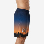 High school basketball shorts in navy and orange sunset gradient with black city skyline hem graphic and white player number 00 on leg panel, side view on adult male model