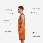 Close detail of slash-mark sublimation on the lower leg panel of the orange and steel-blue reversible basketball shorts