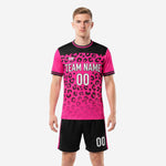 Front view of hot pink and black leopard print custom soccer uniform with team name and number sublimated on jersey and matching shorts
