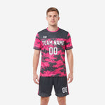 Front view of hot pink and charcoal digital camo custom soccer uniform with team name and number