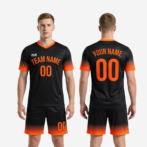 Full kit view of K2 Sportswear sublimated black soccer uniforms in Jet Black and Athletic Orange for men's club and league teams