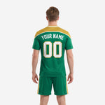 Kelly green soccer jersey and shorts set with varsity arch team name and gold yoke panel