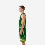 Side view of kelly green basketball uniform showing lime green star-burst side panel on jersey and lime green shorts side insert
