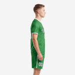 Side view of Kelly Green sublimated soccer uniforms showing white collar trim and side stripe shorts