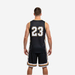 Opposite side view of the league basketball uniform in black and gold with chevron hem band detail on mid-thigh shorts