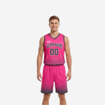 Light and dark reversible basketball uniforms showing pink front side and charcoal reverse side, full set with matching shorts and halftone dot fade pattern