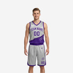 Custom reversible basketball uniform set showing the silver side with purple arched team name and matching silver shorts front view